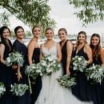 Amanda & her bridesmaids posing outside.