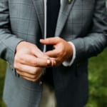 Closeup of Groomsman holding the wedding rings.