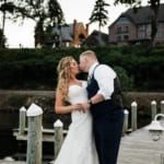 Liz and Bill kissing on the dock.