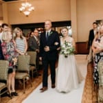 Amanda walking down the aisle with her father.