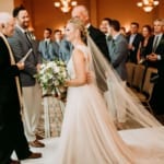 Amanda arriving at the altar with her father and Dan.