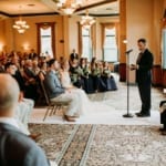 Person reading a speech during the wedding ceremony.