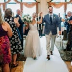 Amanda and Dan walking down the aisle.