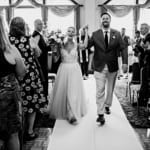 Amanda and Dan walking down the aisle.