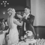 Kelsey and Jared feeding each other cake.