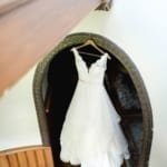 Wedding dress hanging in an alcove.