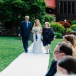 Liz walking down the aisle with her parents.