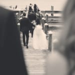 The wedding party walking to the dock.