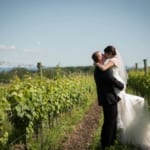 Melissa and Marcin kissing in the winery fields.