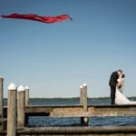 Melissa and Marcin kissing on the dock.