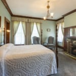 Bed and fireplace in the Collins Room at Belhurst Castle.