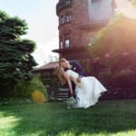 Liz and Bill kissing in front of Belhurst.