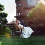 Liz and Bill kissing in front of Belhurst.