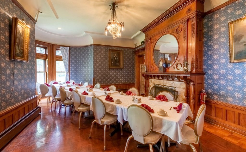 Tables set end-to-end for a large group in the Parlor at Edgar's Restaurant.