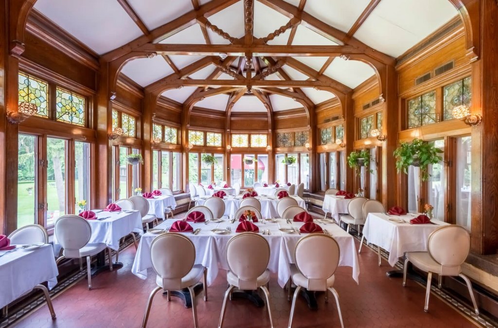 Edgars Steakhouse Solarium with neatly setup tables and chairs.