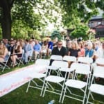 Guests sitting at the outdoor wedding.