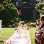 Flower girls walking down the aisle.