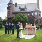 Haley and Matt and the wedding party posing in front of Belhurst.