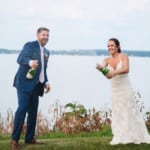 Haley & Matt spraying champagne lakeside.