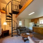 Ice House - kitchen, sitting area, and spiral stairs to loft. Ice House - kitchen, sitting area, and spiral stairs to loft.