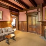 Lewis Suite - Side room with fireplace and sofa.