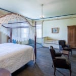 Living Room - bed, fireplace, armoire, jacuzzi tub.