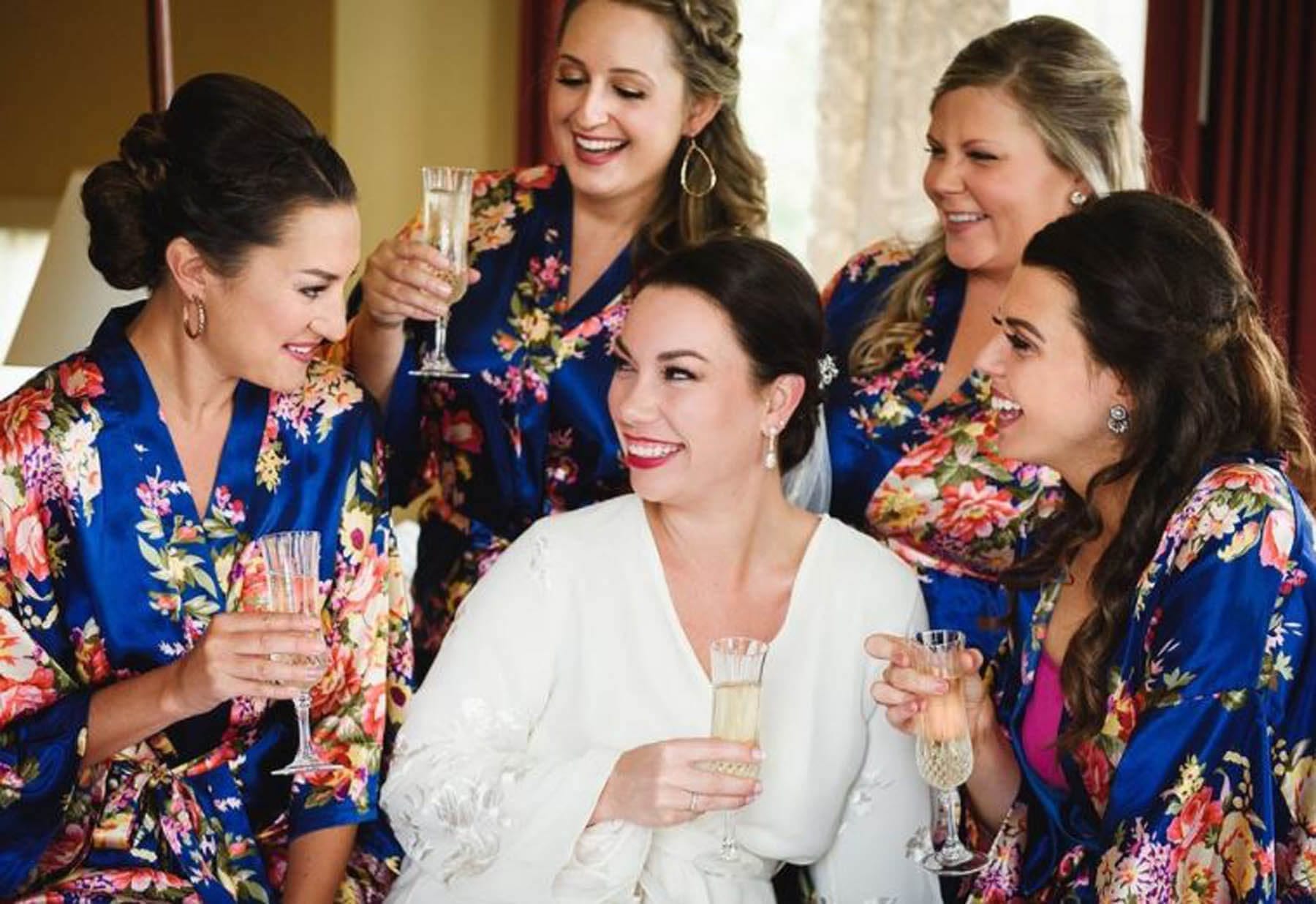 Bride and Bridesmaids in spa robes with champagne.