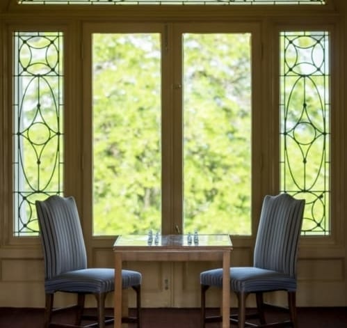 Table and two chairs by a window.