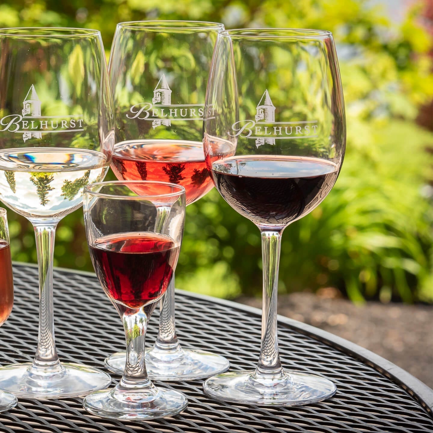 Assortment of wine glasses on a patio table.