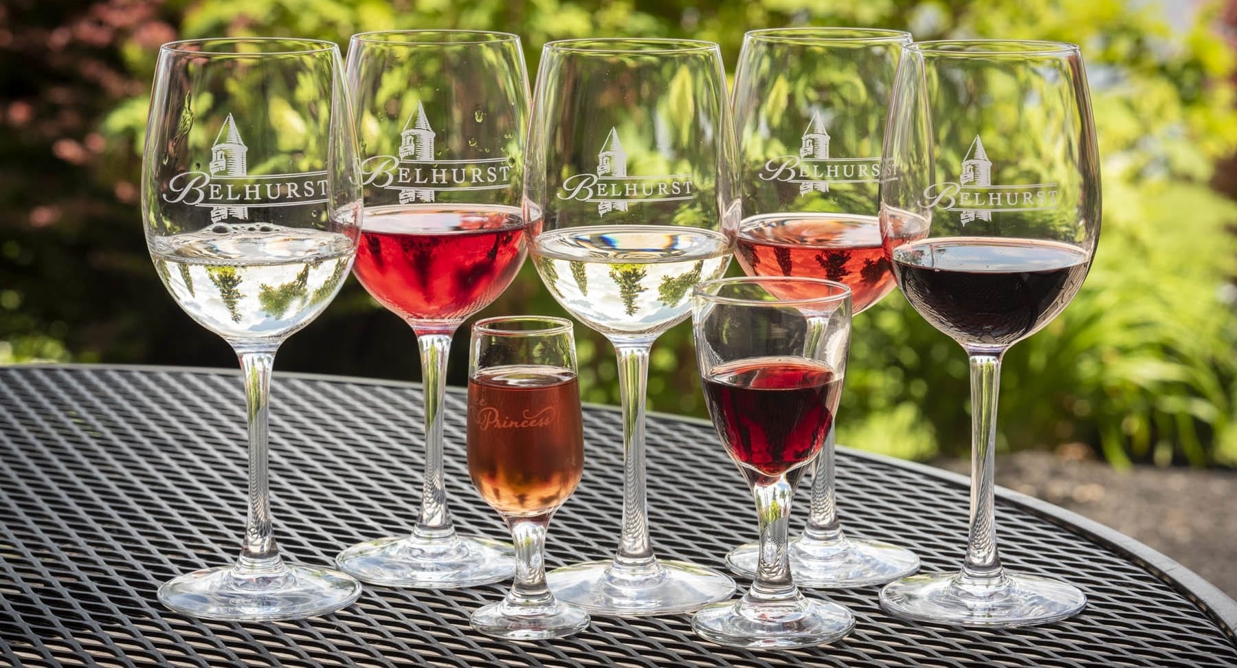 Belhurst wine glasses with assortment of wine in each.