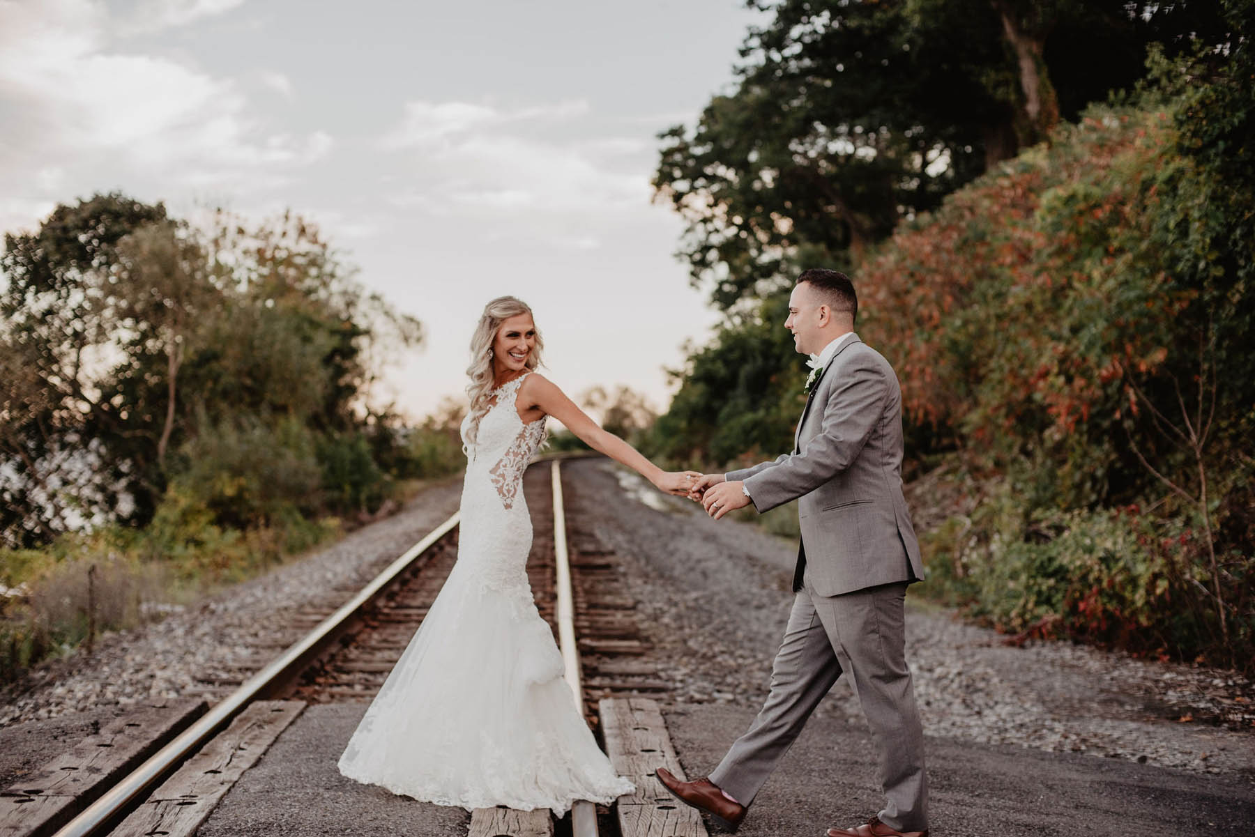 previews-21 Wedding couple walking across railroad tracks.
