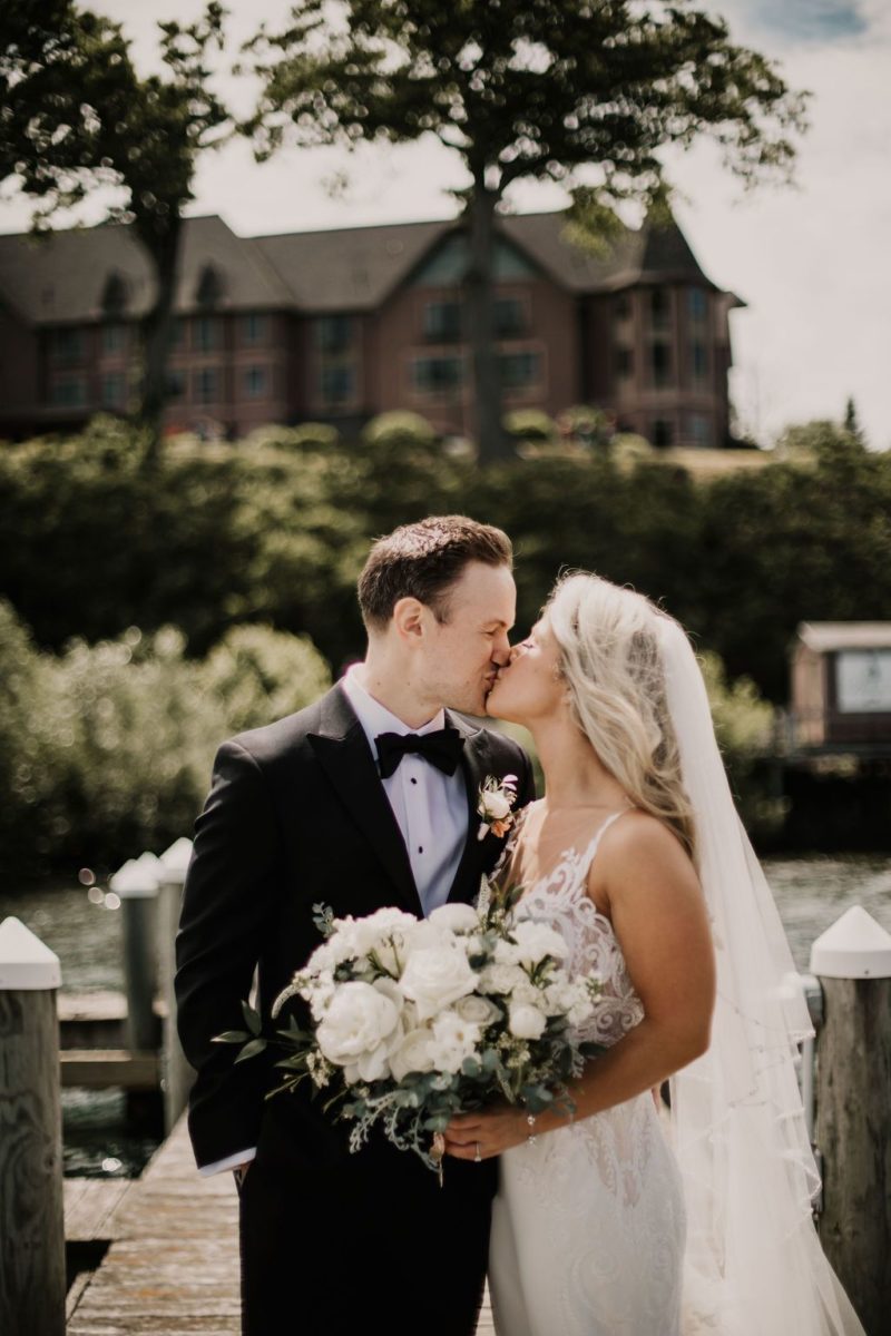 Bride and Groom kissing outdoors. Photo by Birds of Passage Collective.